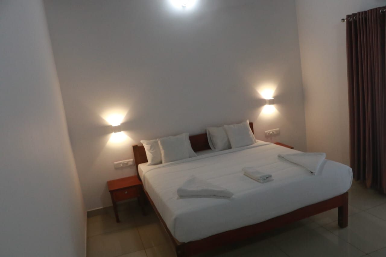 Bedroom with soft lighting and white linen